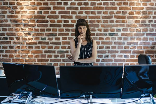 businesswoman-looking-at-a-row-of-monitors-2024-09-21-17-29-44-utc.jpg