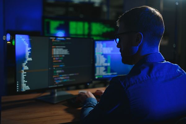 programmer-working-at-desk-in-office-2024-08-06-00-31-10-utc.jpg