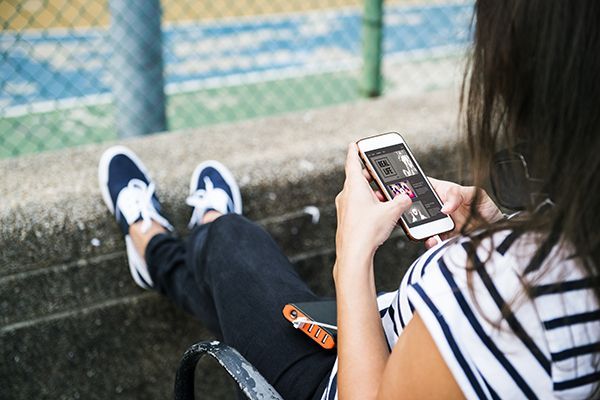 young-woman-using-a-smartphone-at-the-park-2023-11-27-05-09-13-utc.jpg
