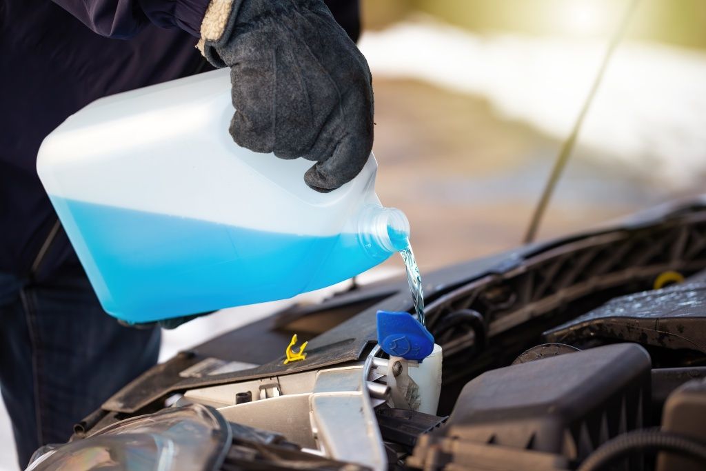 man-filling-antifreeze-coolant-for-cleaning-front-2024-12-05-11-45-57-utc.jpg