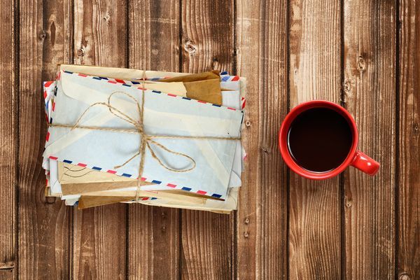 pile-of-old-envelopes-and-coffee-cup-on-wooden-tab-2024-09-16-23-29-18-utc.jpg