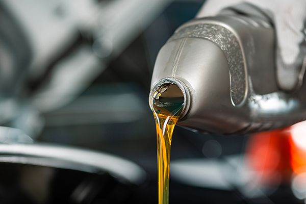 partial-view-of-mechanic-pouring-motor-oil-from-bo-2024-11-18-11-47-34-utc.jpg