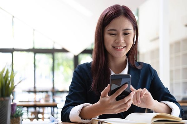 asian-woman-talking-on-the-phone-and-working-on-a-2025-01-16-13-24-47-utc.jpg
